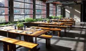 Elegant dining room with empty tables and sun shining through windows