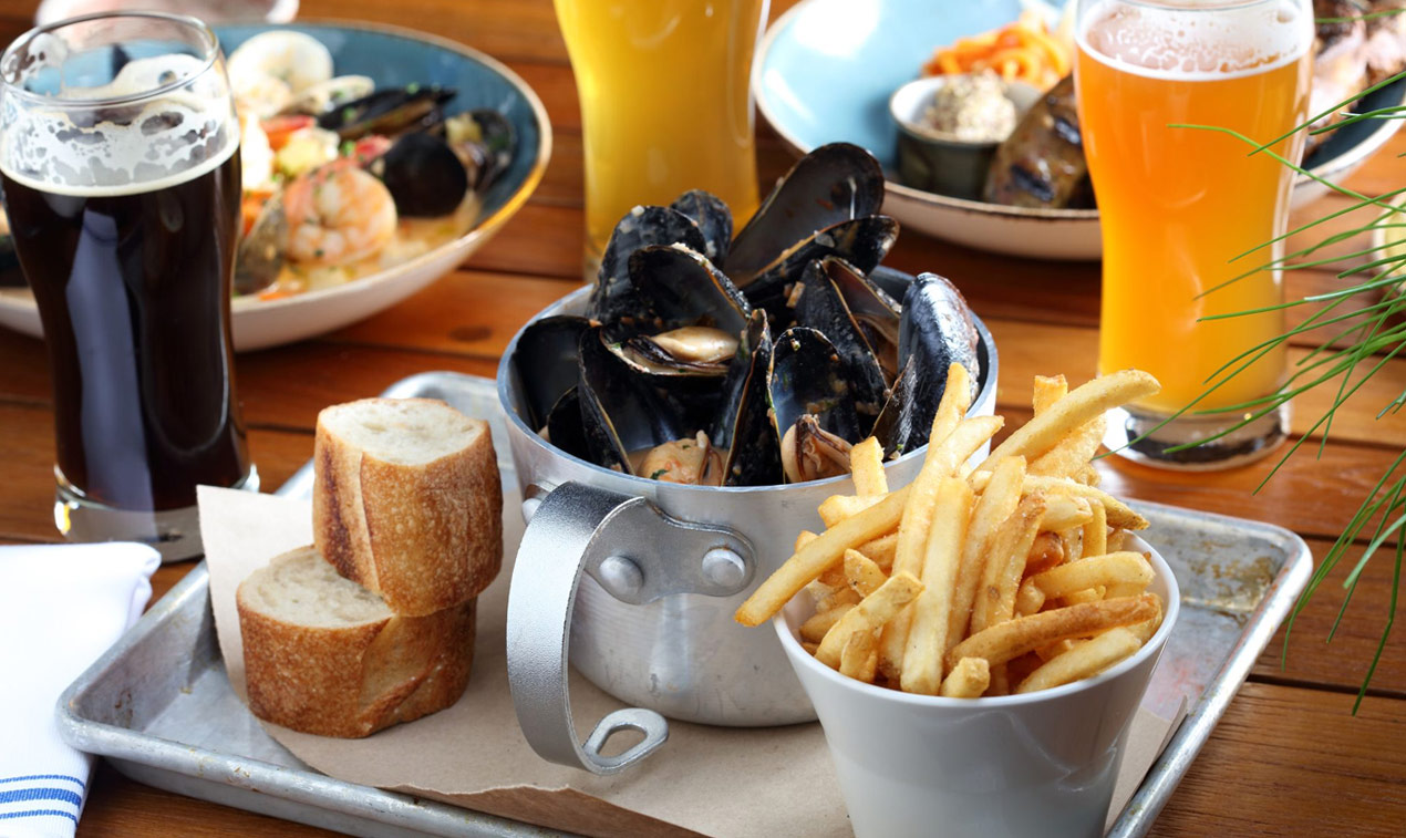 Trays with plates with food, glasses with beer