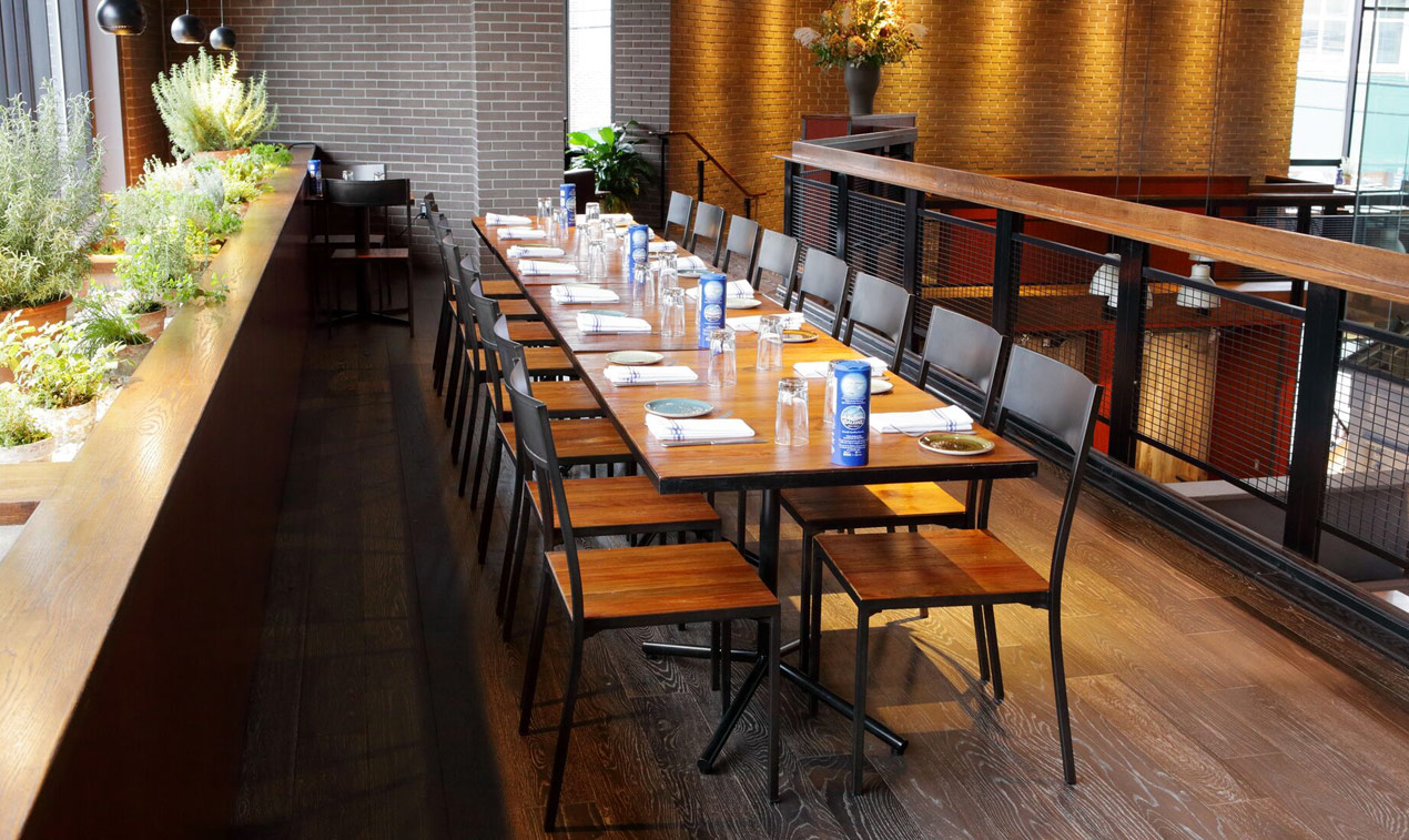 Long table set for dinner with empty seats